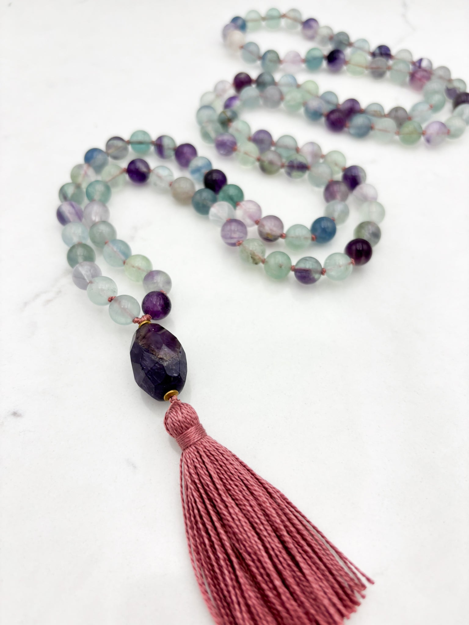 fluorite gemstone mala with amethyst guru bead and pink tassel | radiant malas  handmade in boulder, colorado