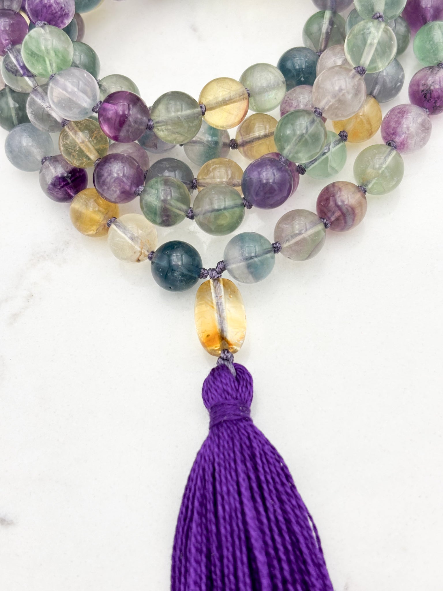 fluorite gemstone mala with citrine guru bead and purple tassel | radiant malas  handmade in boulder, colorado