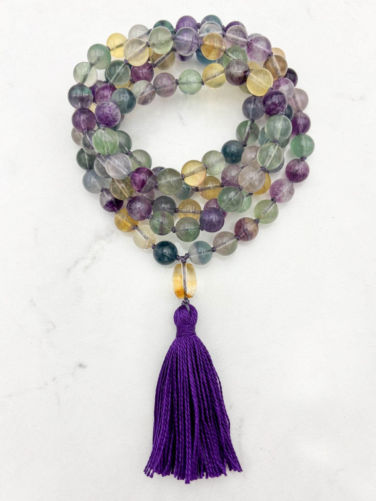 fluorite gemstone mala with citrine guru bead and purple tassel | radiant malas  handmade in boulder, colorado