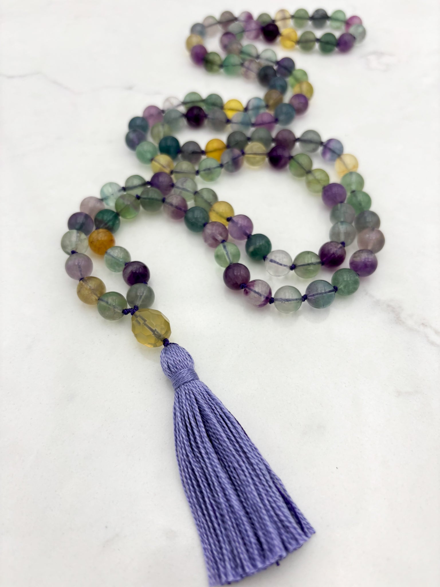 fluorite gemstone mala with citrine guru bead and lilac tassel | radiant malas  handmade in boulder, colorado