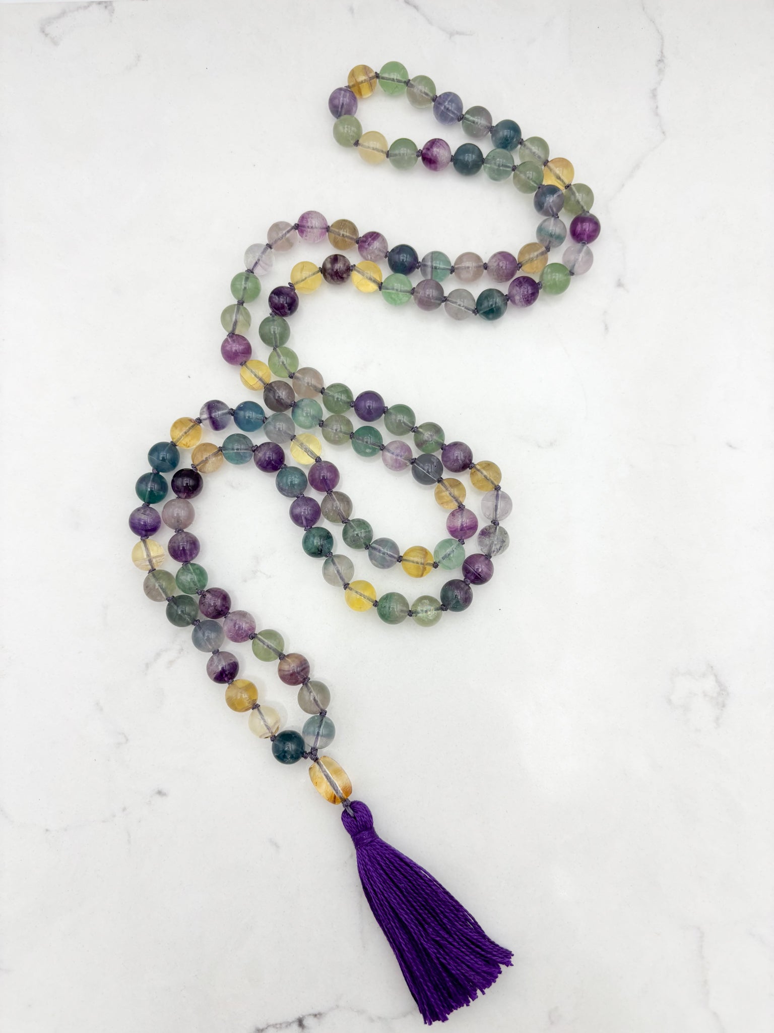 fluorite gemstone mala with citrine guru bead and purple tassel | radiant malas  handmade in boulder, colorado
