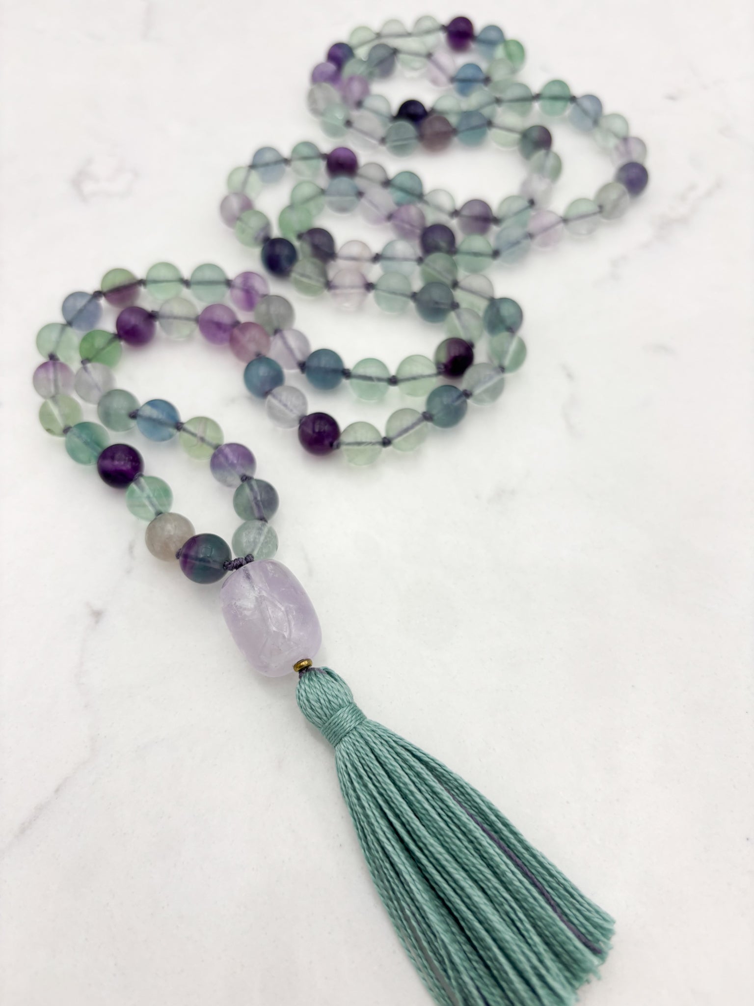 fluorite gemstone mala with amethyst guru bead and purple tassel | radiant malas  handmade in boulder, colorado