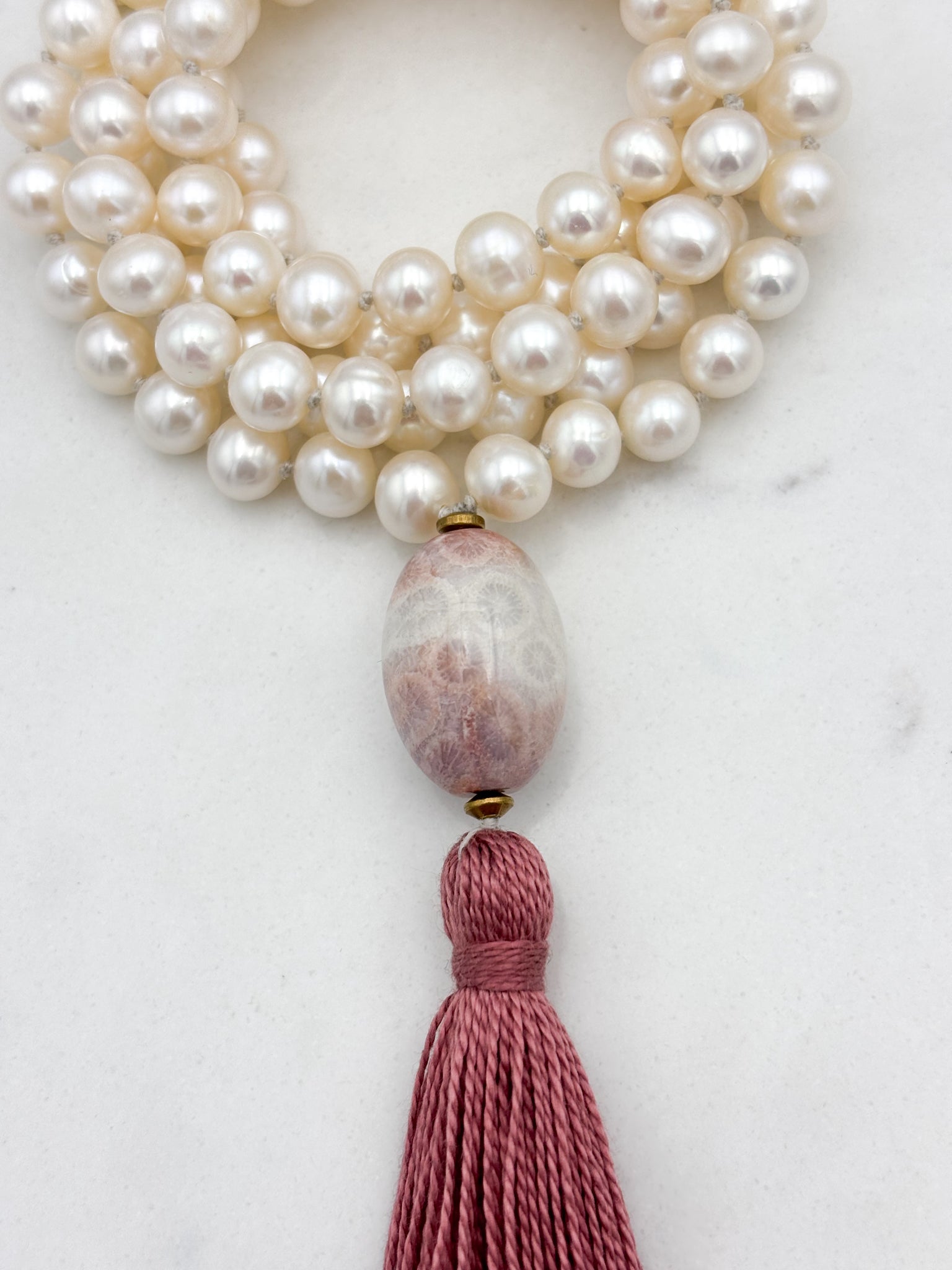 freshwater pearl mala necklace with fossil coral guru bead and rose pink tassel | radiant malas | handmade in boulder, colorado