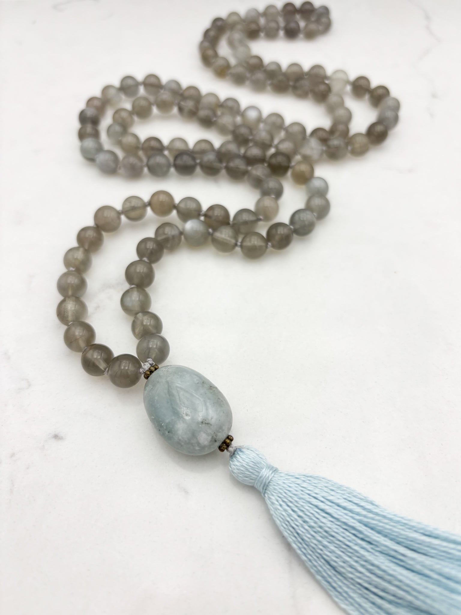 gray moonstone gemstone mala necklace with aquamarine guru bead and blue tassel | handmade in boulder, colorado | radiant malas