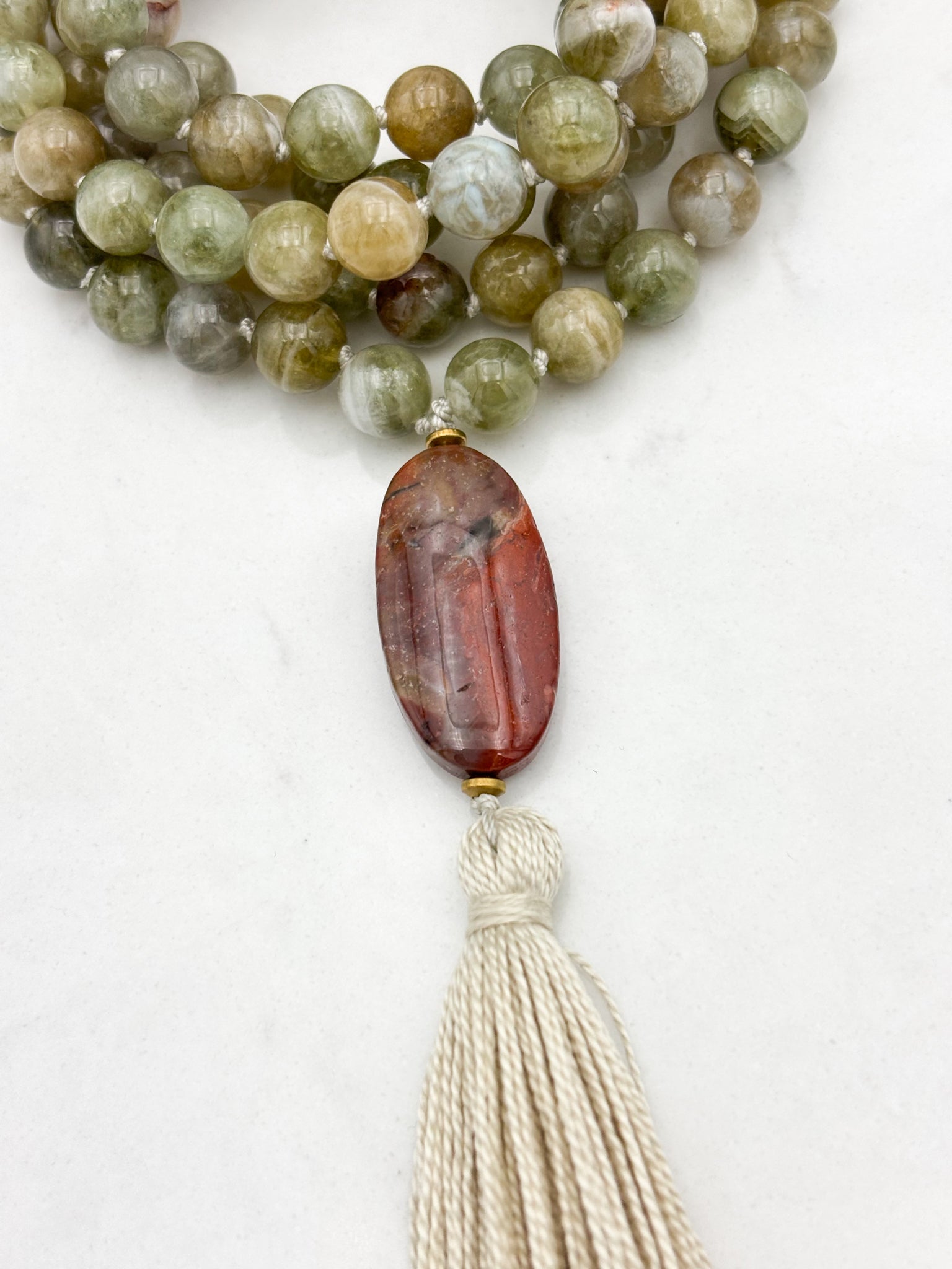green garnet gemstone mala with red jasper guru bead and cream colored tassel | radiant malas | handmade in boulder, colorado