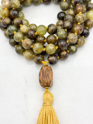 green garnet gemstone mala with palmwood guru bead and yellow colored tassel | radiant malas | handmade in boulder, colorado