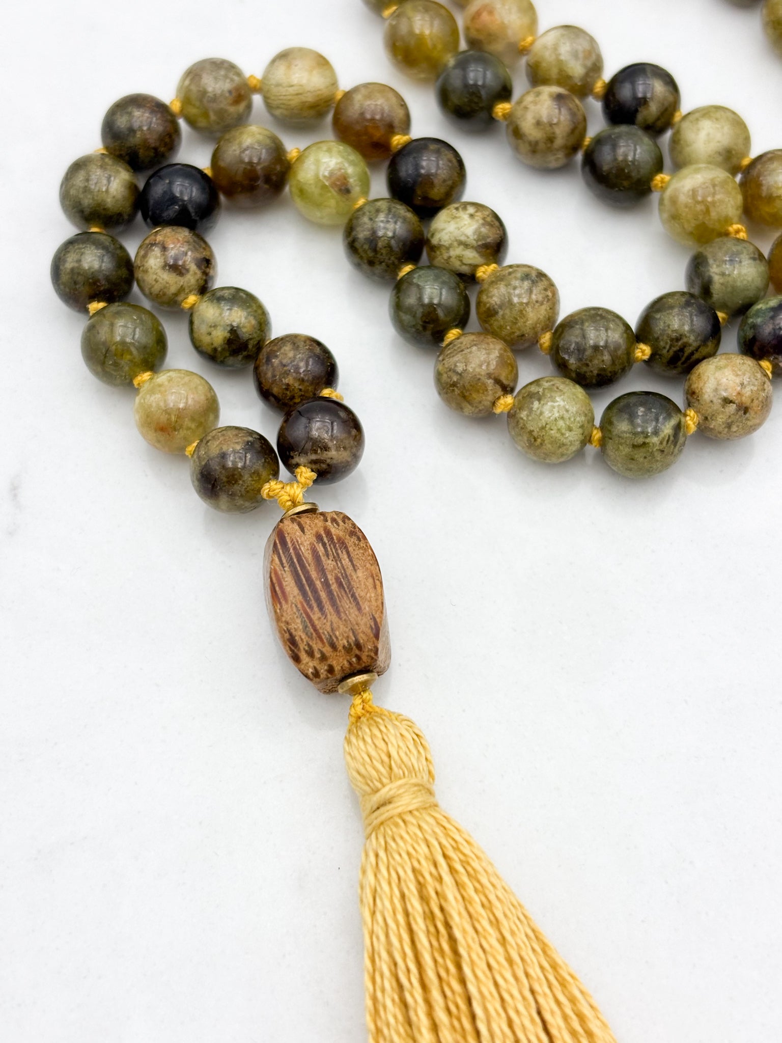 green garnet gemstone mala with palmwood guru bead and yellow colored tassel | radiant malas | handmade in boulder, colorado
