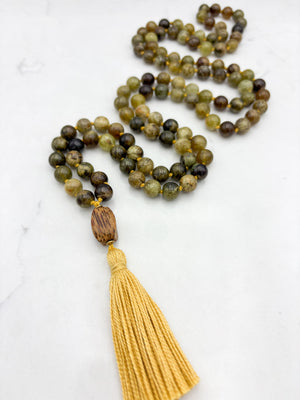 green garnet gemstone mala with palmwood guru bead and yellow colored tassel | radiant malas | handmade in boulder, colorado