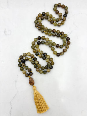 green garnet gemstone mala with palmwood guru bead and yellow colored tassel | radiant malas | handmade in boulder, colorado