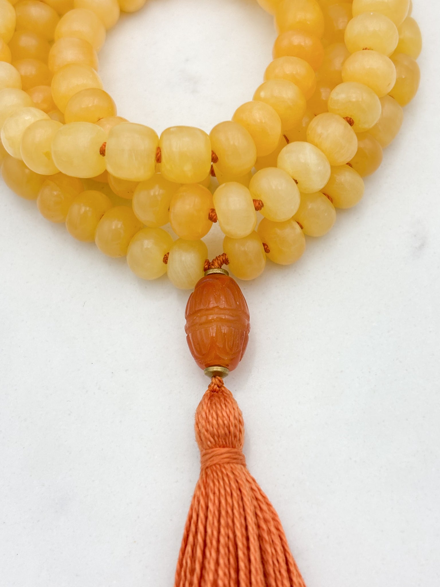 Honey Calcite gemstone mala with carnelian guru bead and orange tassel | radiant malas  | handmade in boulder, colorado
