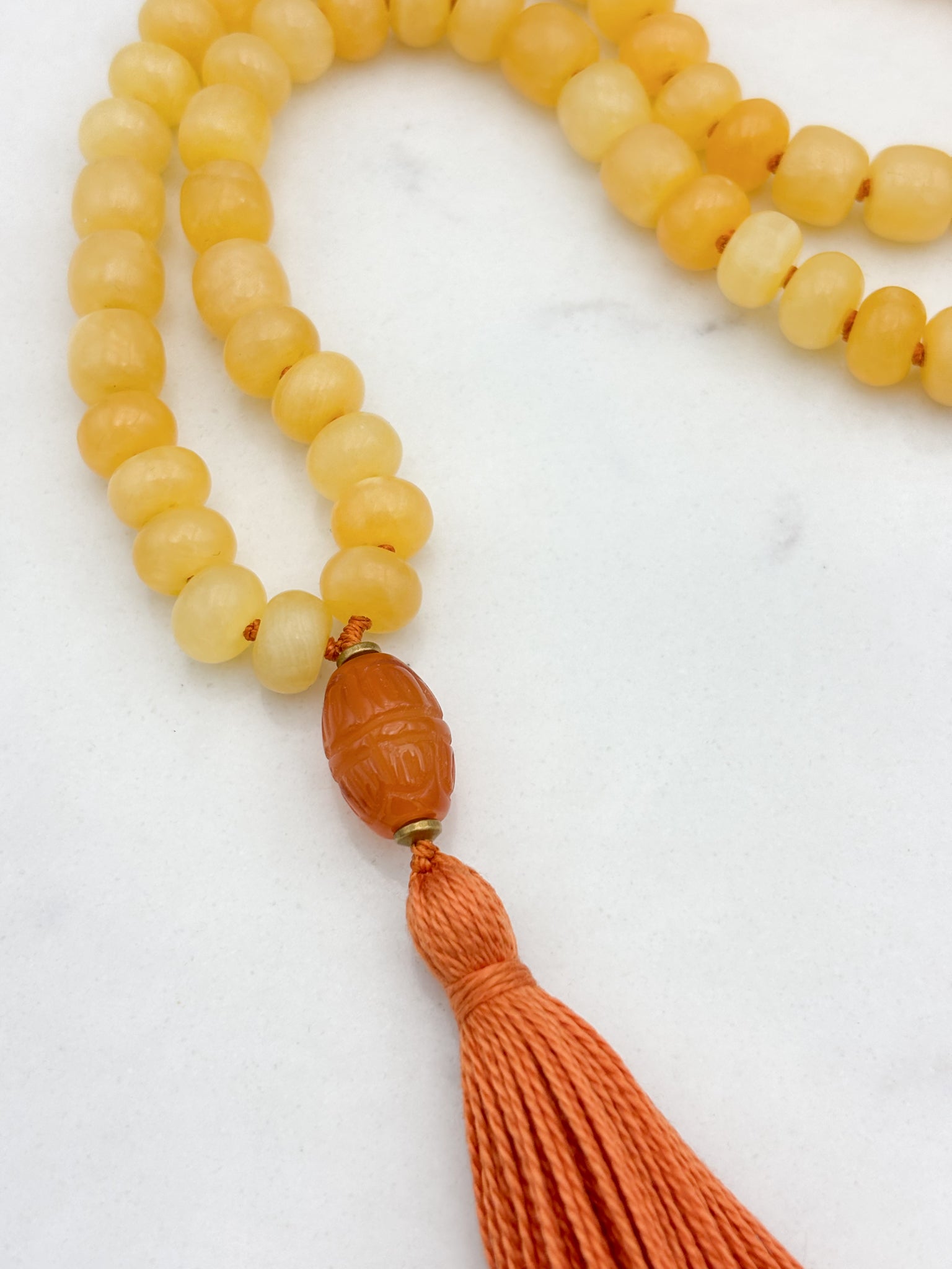 Honey Calcite gemstone mala with carnelian guru bead and orange tassel | radiant malas  | handmade in boulder, colorado