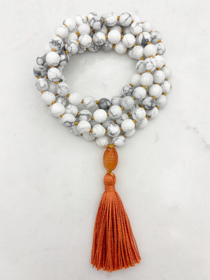 howlite gemstone mala with carnelian guru bead and orange tassel | radiant malas | handmade in boulder, colorado