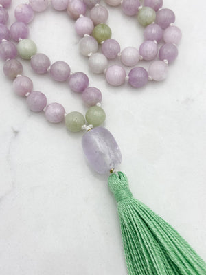 kunzite gemstone mala with lilac amethyst guru bead and green tassel | radiant malas  handmade in boulder, colorado