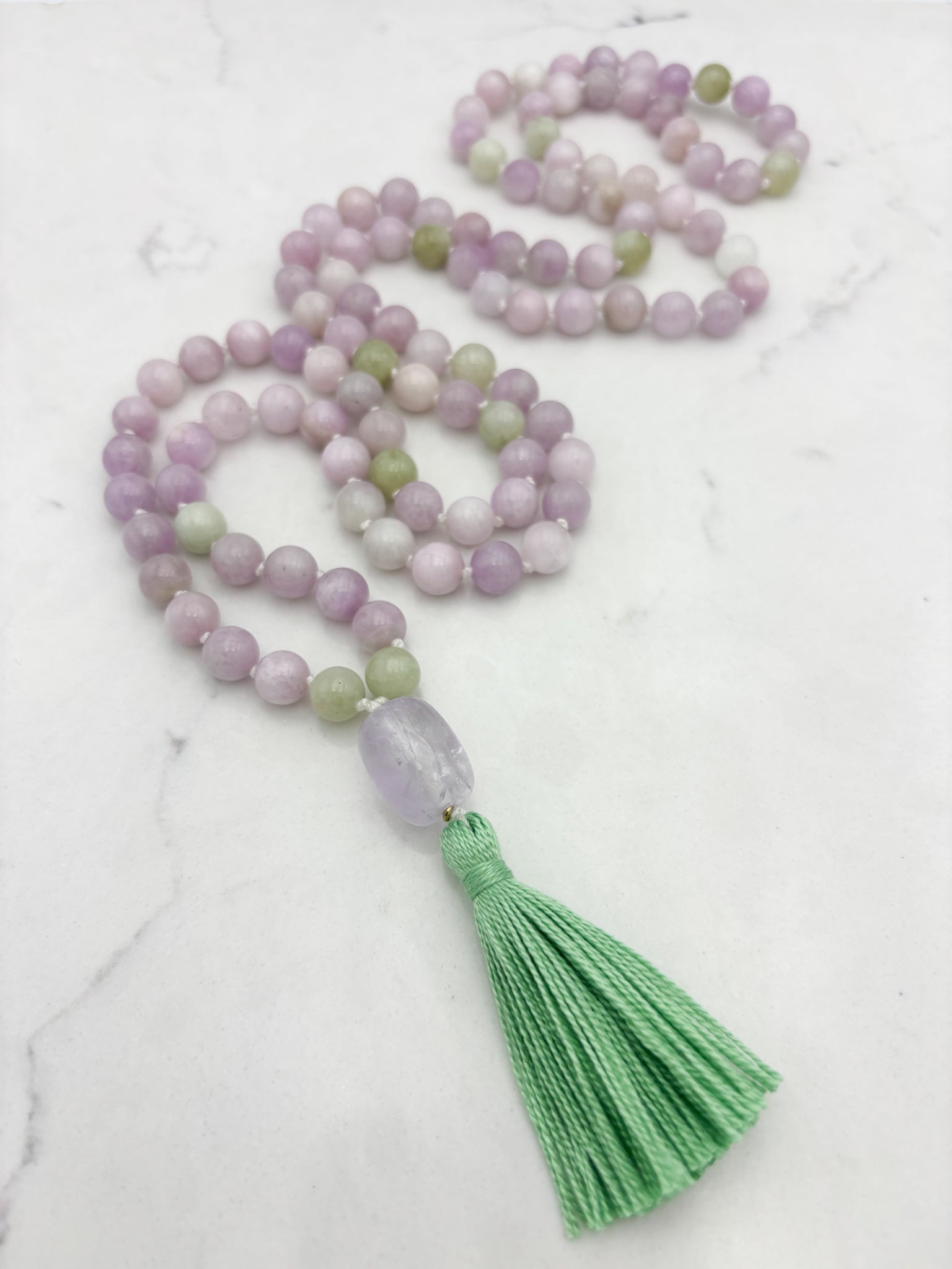 kunzite gemstone mala with lilac amethyst guru bead and green tassel | radiant malas  handmade in boulder, colorado