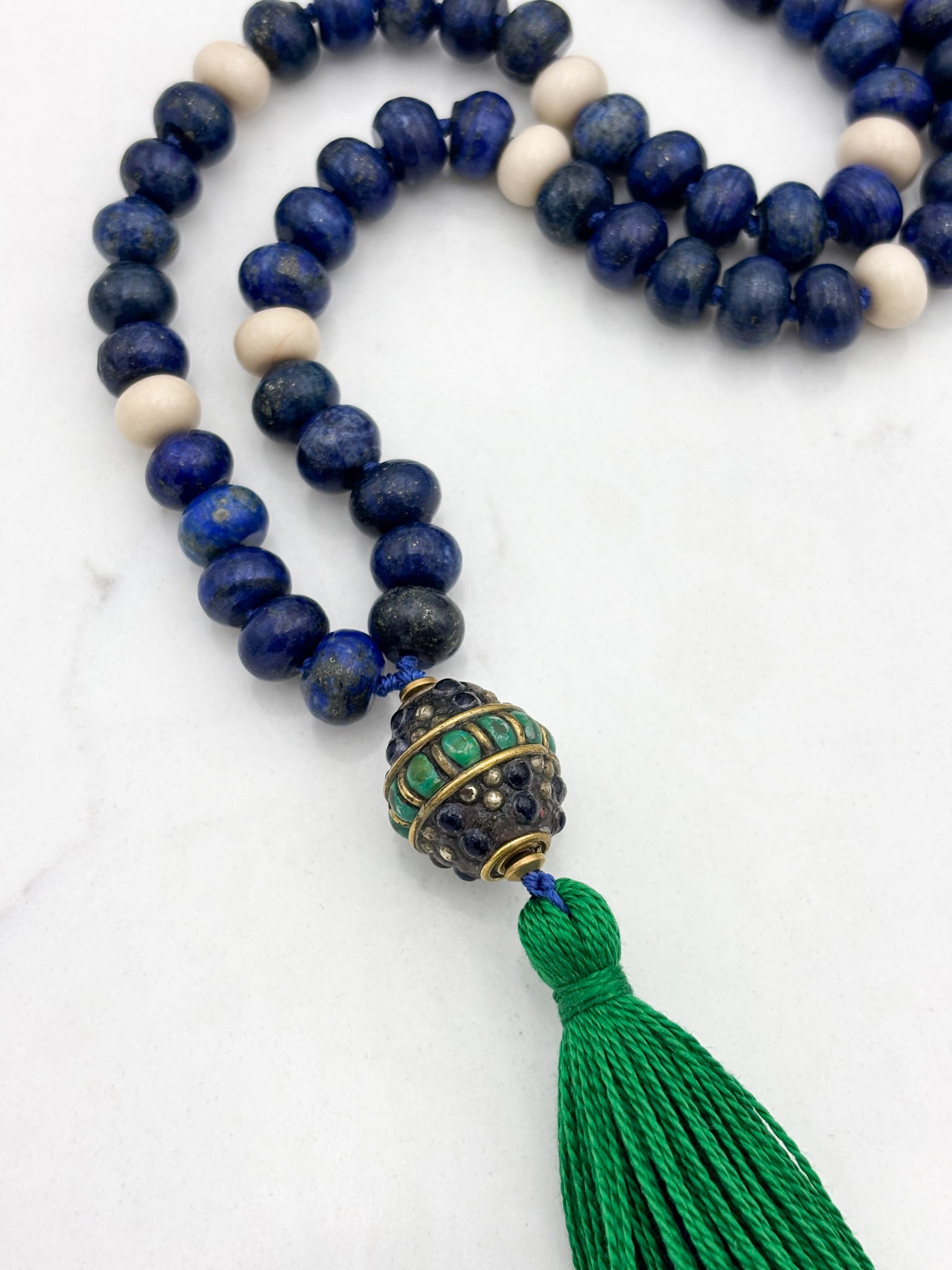 lapis and fossil jasper gemstone mala with vintage brass, lapis, turquoise guru bead and green tassel | radiant malas | handmade in boulder, colorado