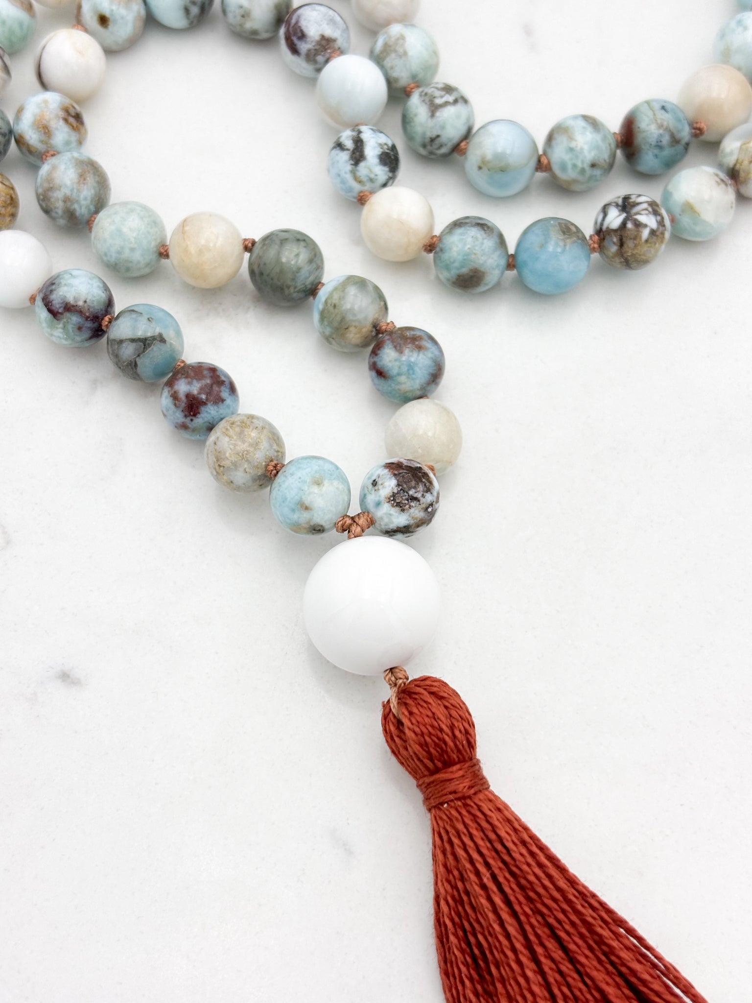larimar gemstone mala with white agate guru bead and rust tassel | radiant malas | handmade in boulder, colorado