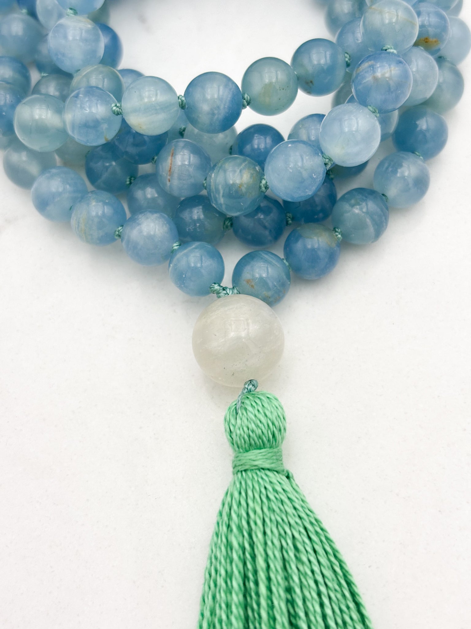 lemurian aquatine calcite gemstone mala with moonstone guru bead and green tassel | radiant malas | handmade in boulder, colorado