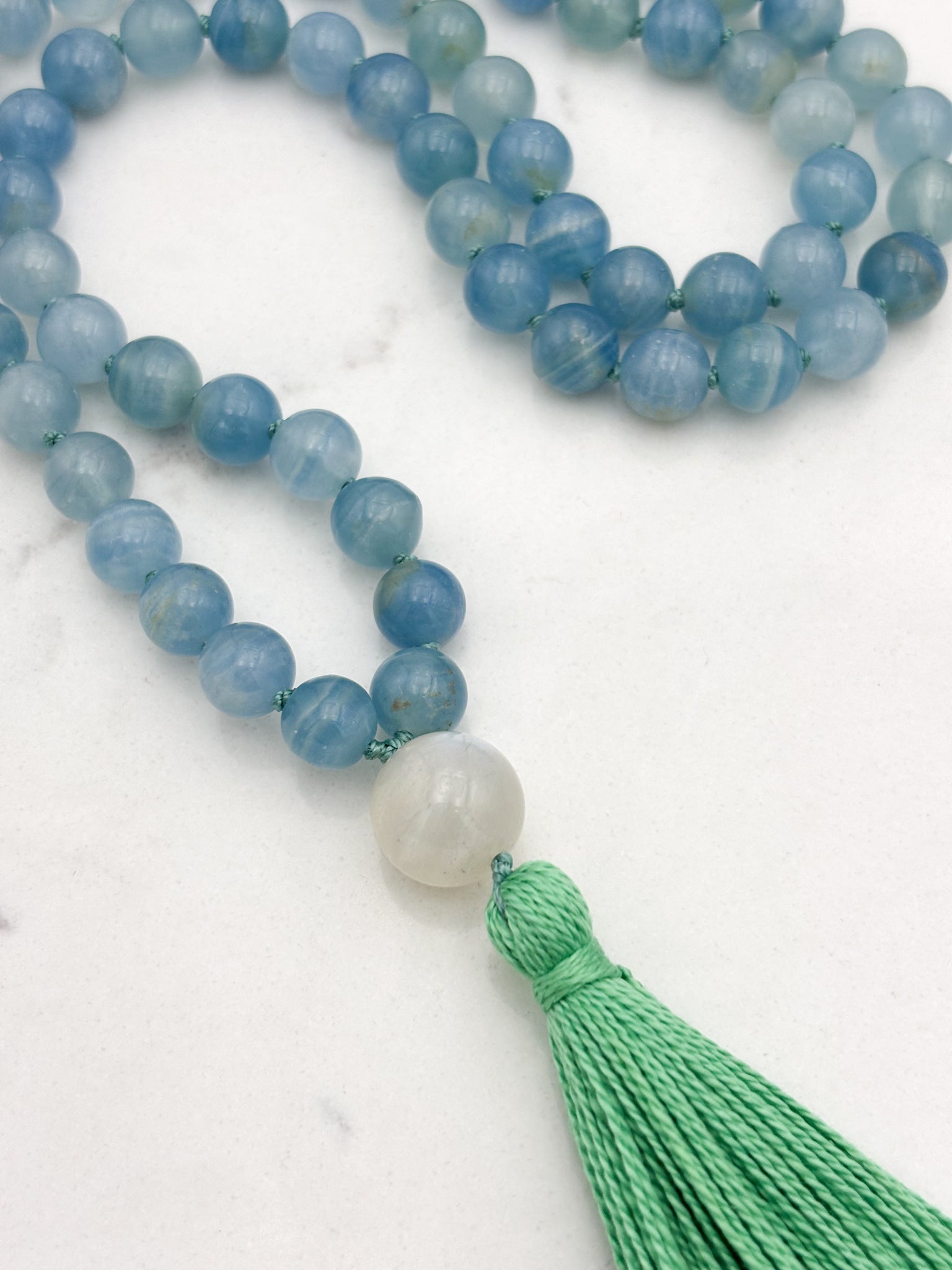 lemurian aquatine calcite gemstone mala with moonstone guru bead and green tassel | radiant malas | handmade in boulder, colorado