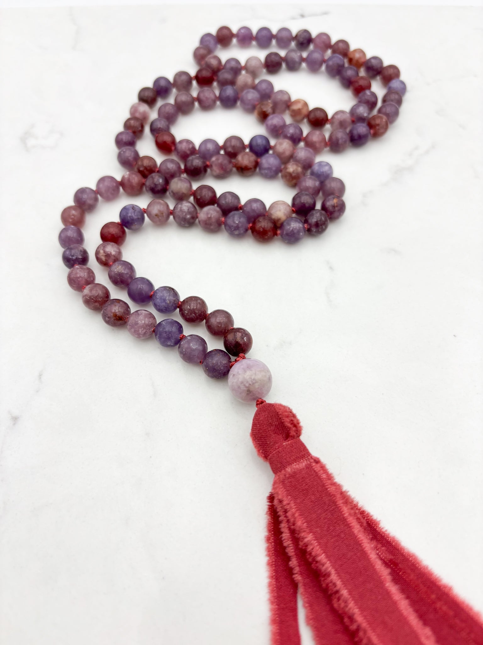 lepidolite gemstone mala necklace with kunzite guru bead and red silk  tassel | radiant malas | handmade in boulder, colorado