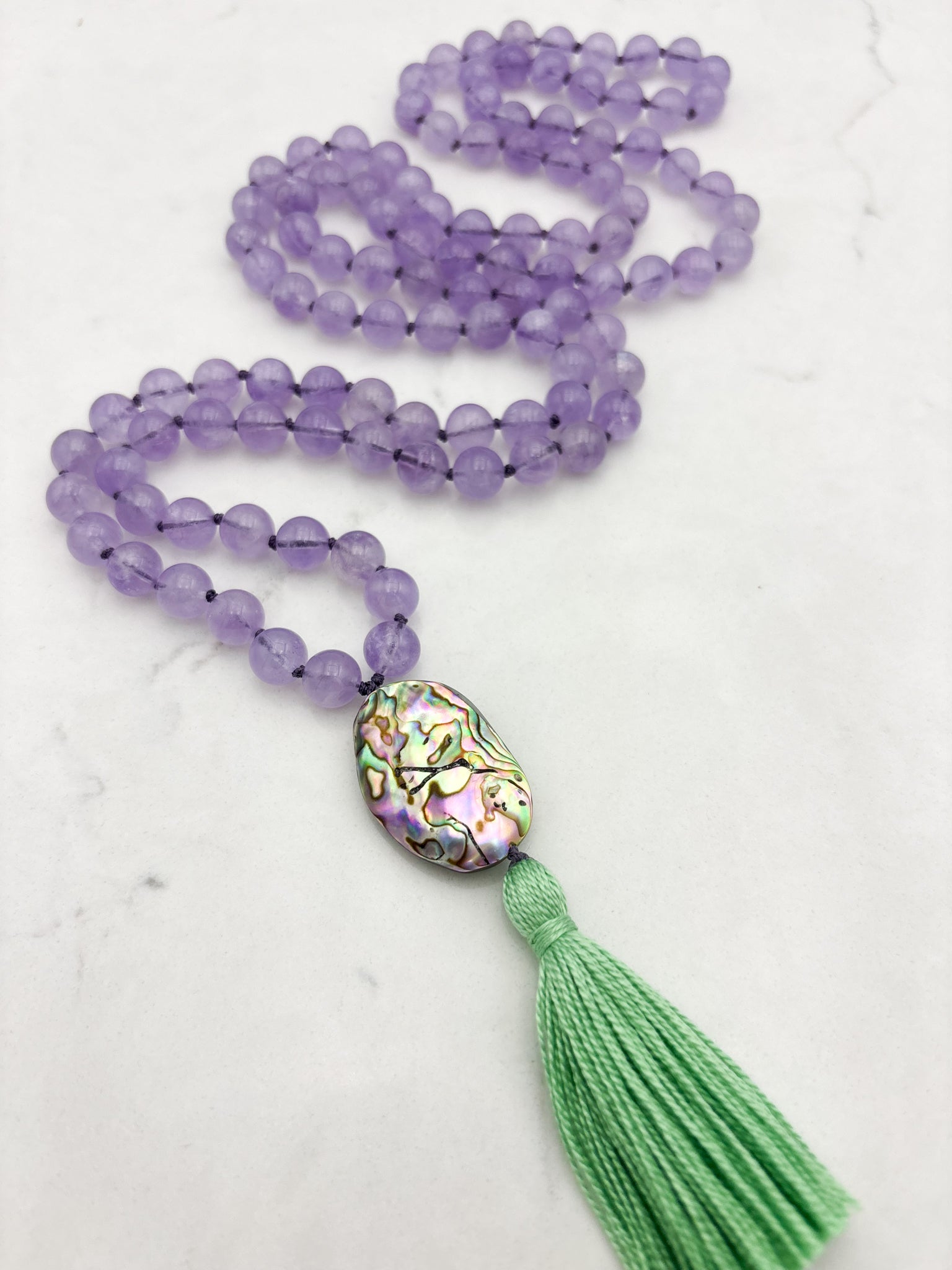 lilac amethyst gemstone mala with abalone shell guru bead and green tassel | radiant malas | handmade in boulder, colorado