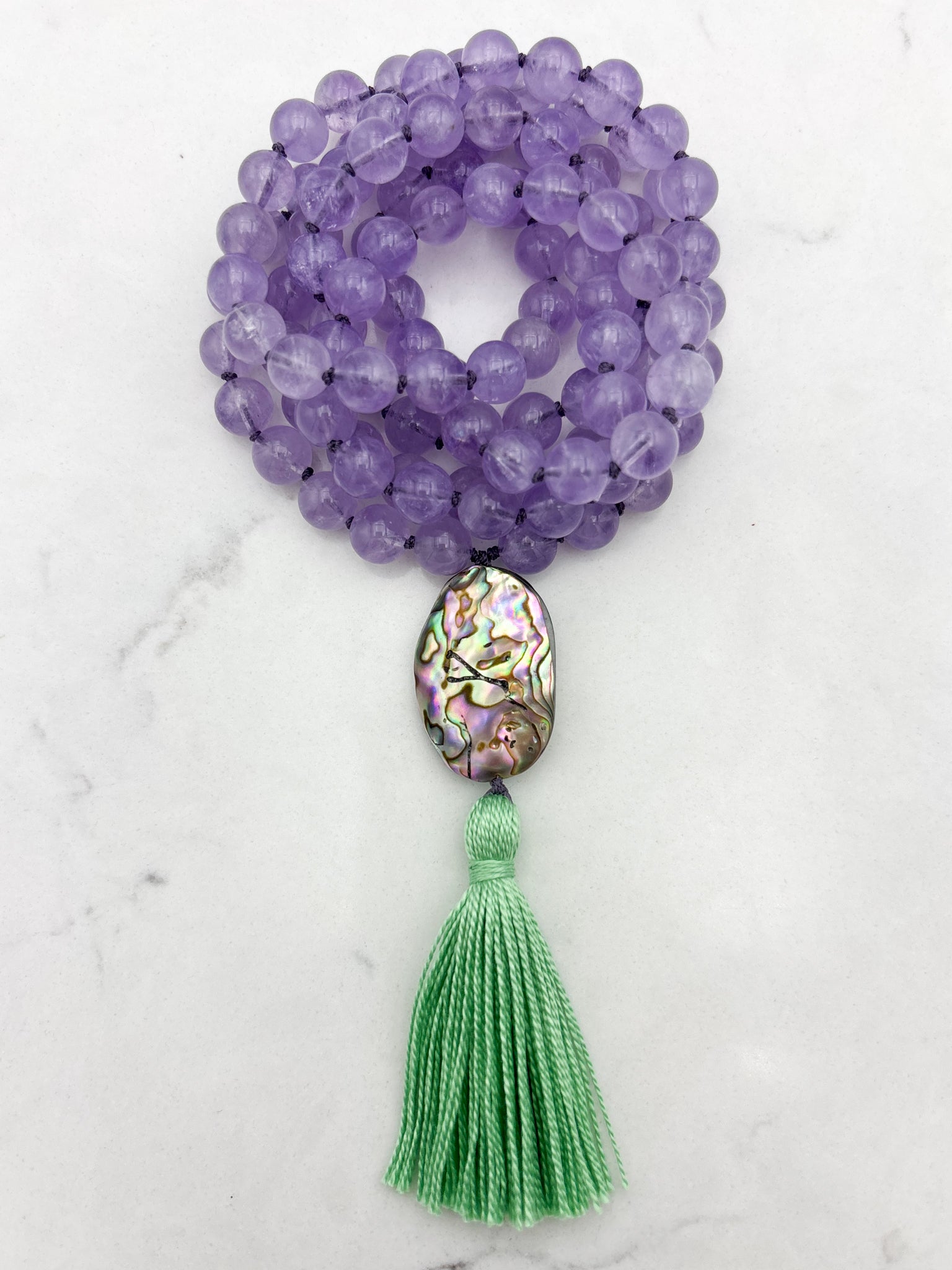 lilac amethyst gemstone mala with abalone shell guru bead and green tassel | radiant malas | handmade in boulder, colorado