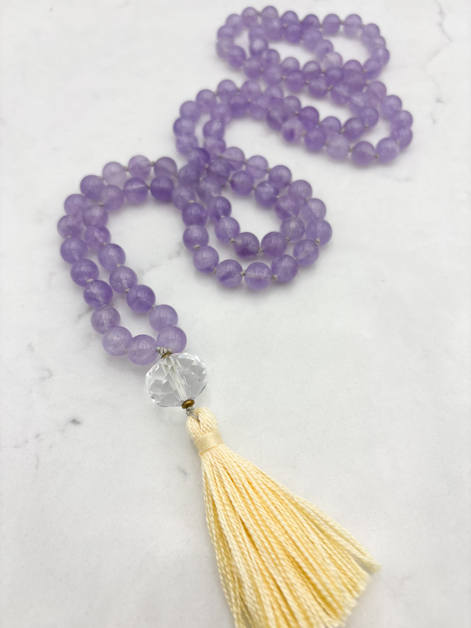 lilac amethyst gemstone mala with faceted quartz guru bead and yellow tassel | radiant malas | handmade in boulder, colorado