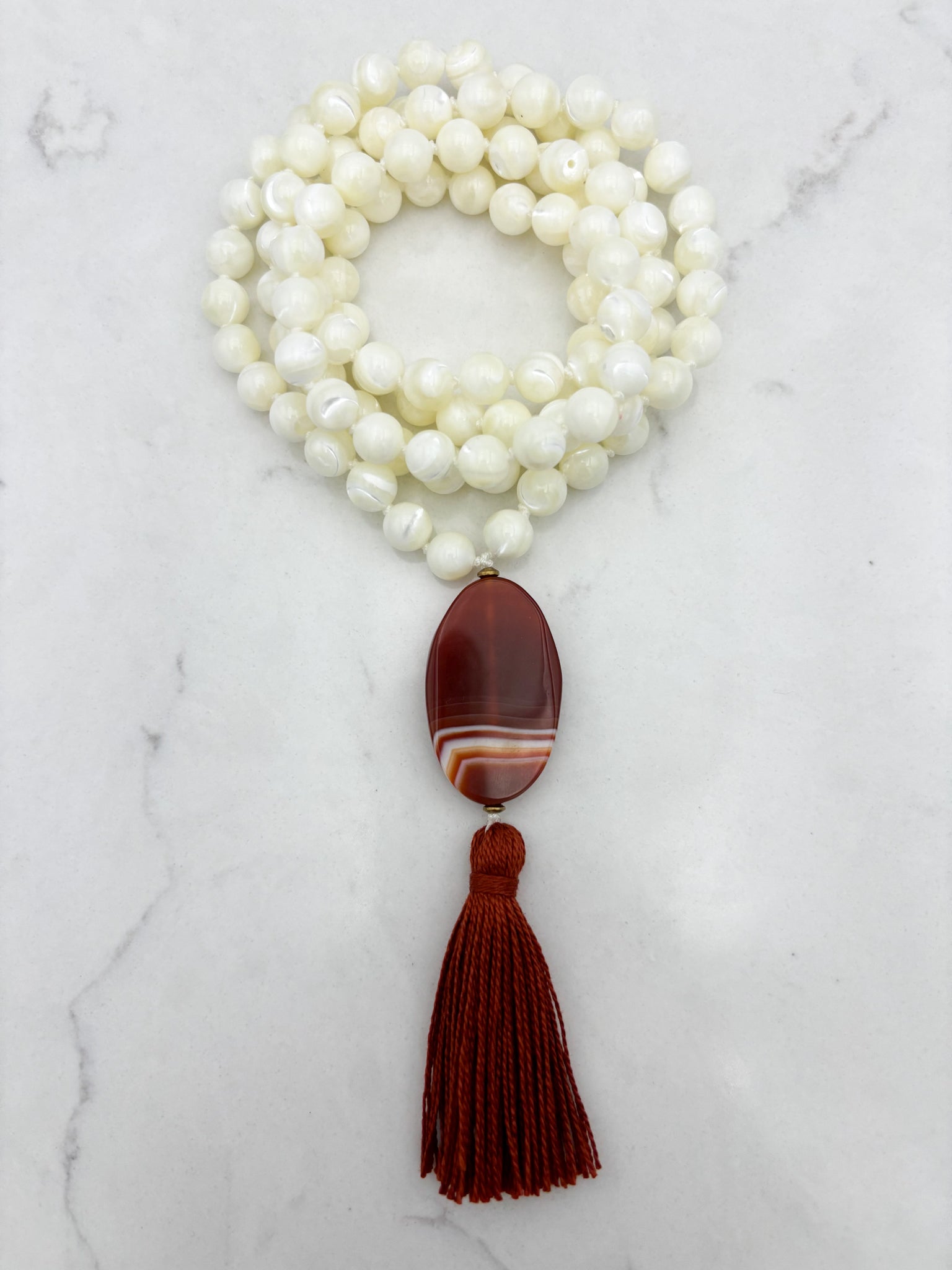 mother of pearl gemstone mala with red botswana agate guru bead and rust tassel | radiant malas | handmade in boulder, colorado