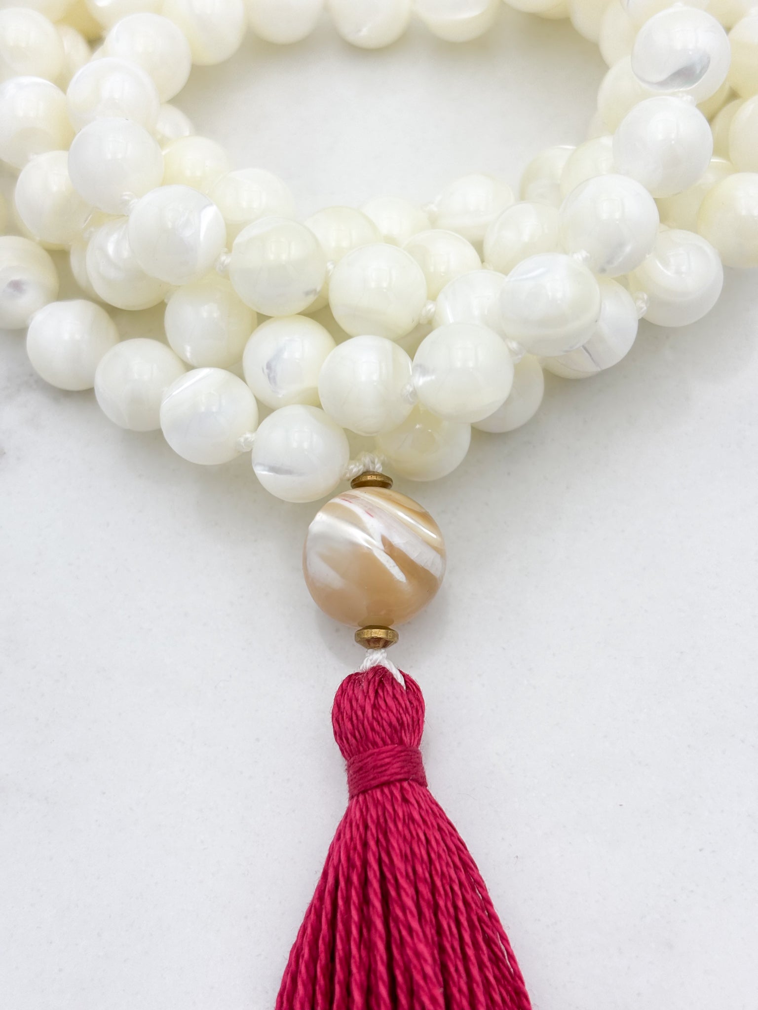 mother of pearl gemstone mala with mother of pearl guru bead and pink tassel | radiant malas | handmade in boulder, colorado