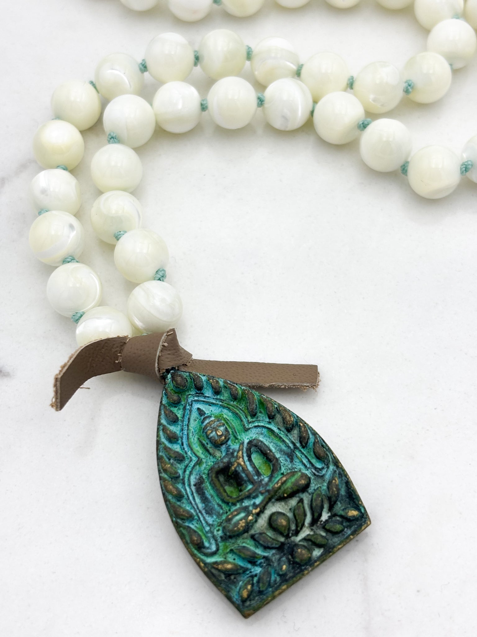 mother of pearl gemstone mala necklace with green brass buddha pendant | radiant malas | handmade in boulder, colorado