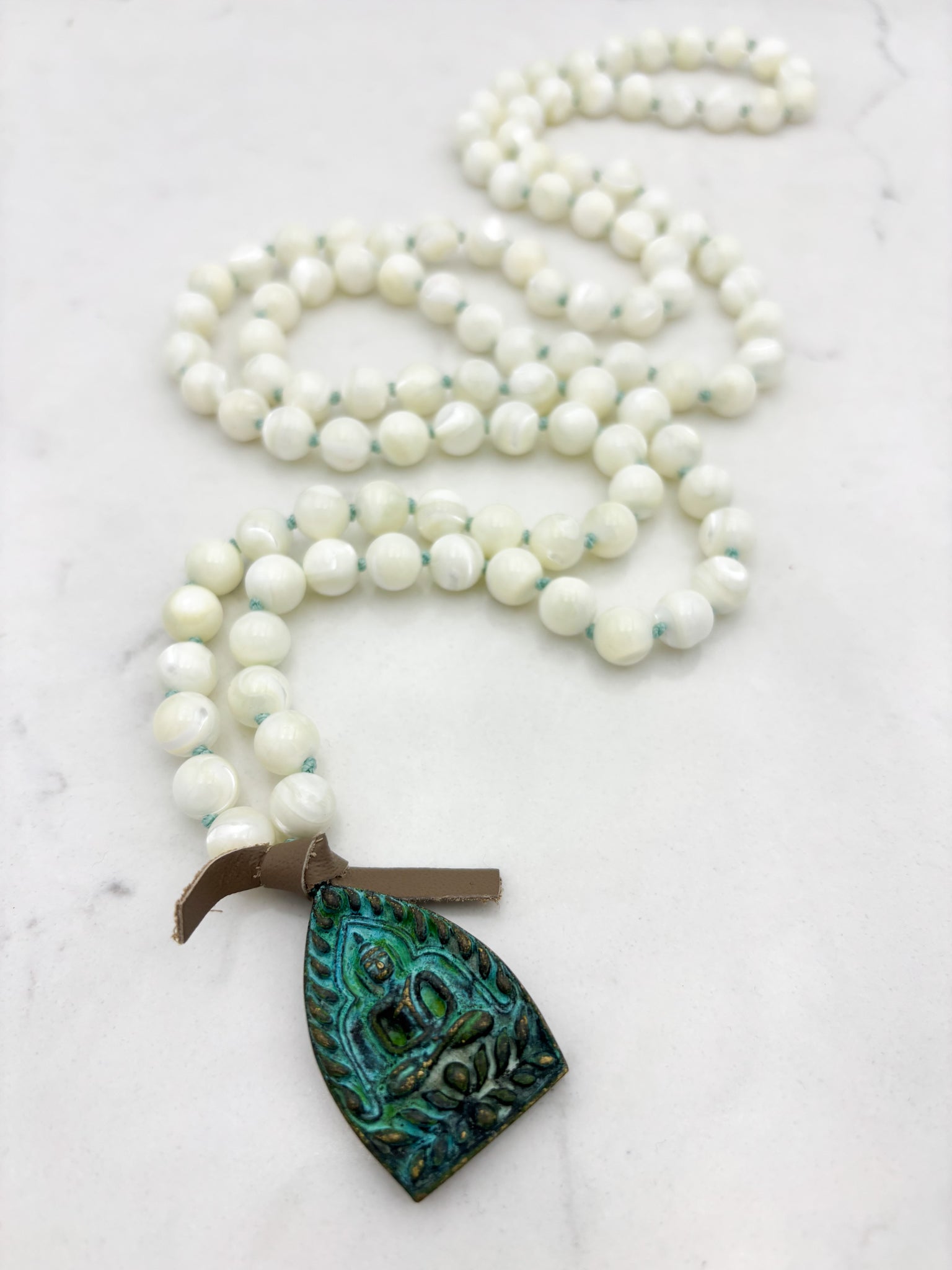 mother of pearl gemstone mala necklace with green brass buddha pendant | radiant malas | handmade in boulder, colorado