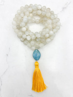 moonstone gemstone mala necklace with carved blue glass guru bead and yellow tassel | handmade in boulder, colorado | radiant malas