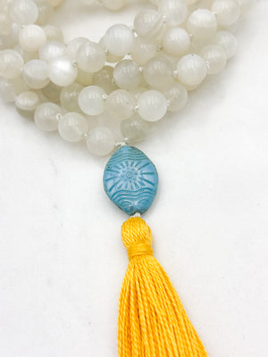 moonstone gemstone mala necklace with carved blue glass guru bead and yellow tassel | handmade in boulder, colorado | radiant malas