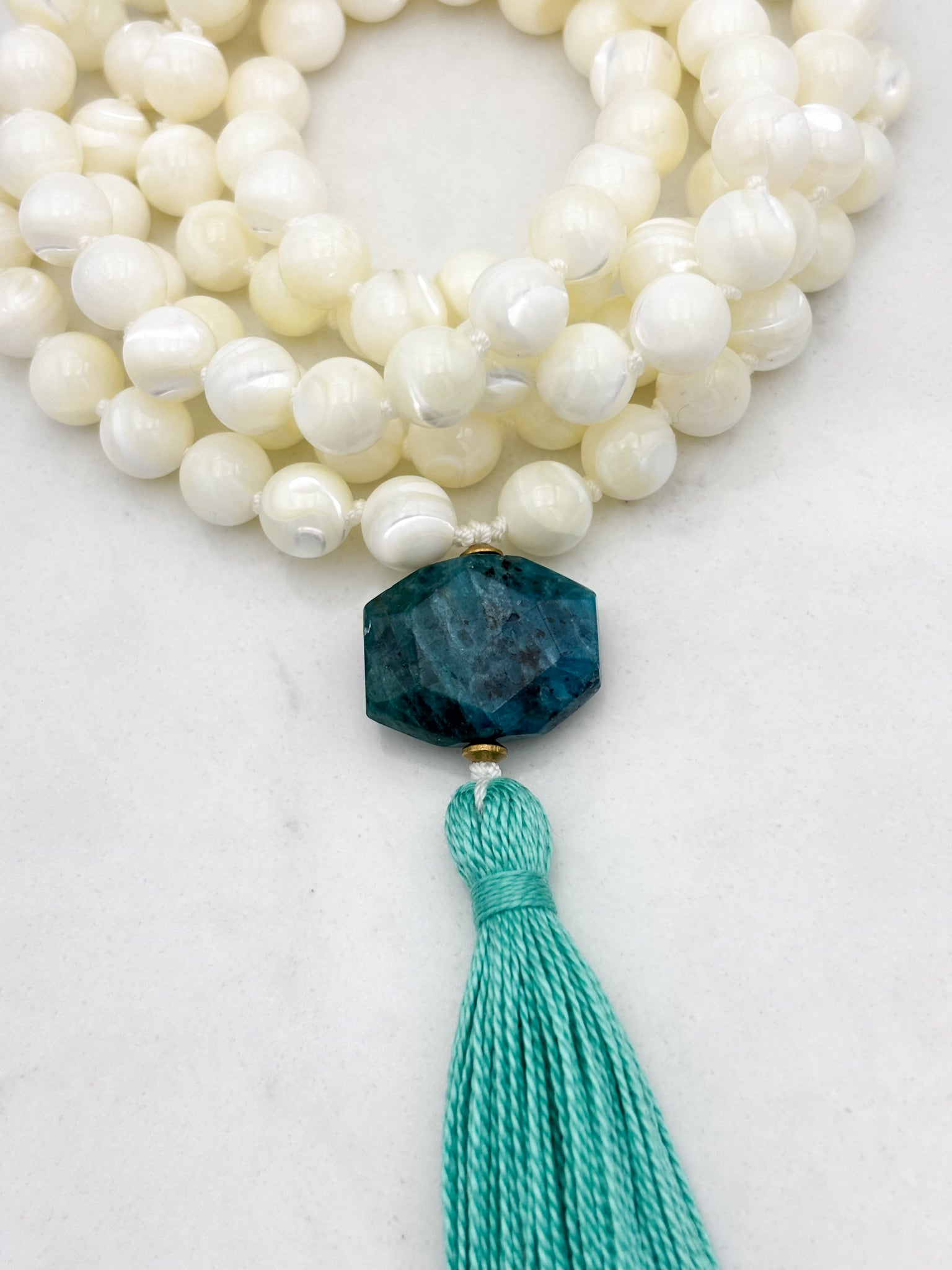 mother of pearl gemstone mala with blue apatite guru bead and teal tassel 
| radiant malas | handmade in boulder, colorado