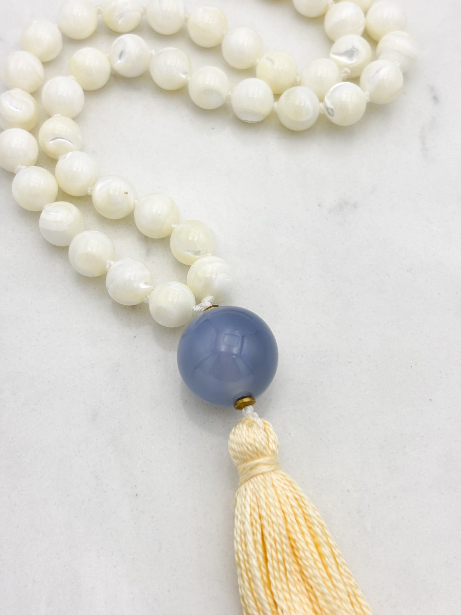 mother of pearl gemstone mala with chalcedony guru bead and pale yellow tassel | radiant malas | handmade in boulder, colorado