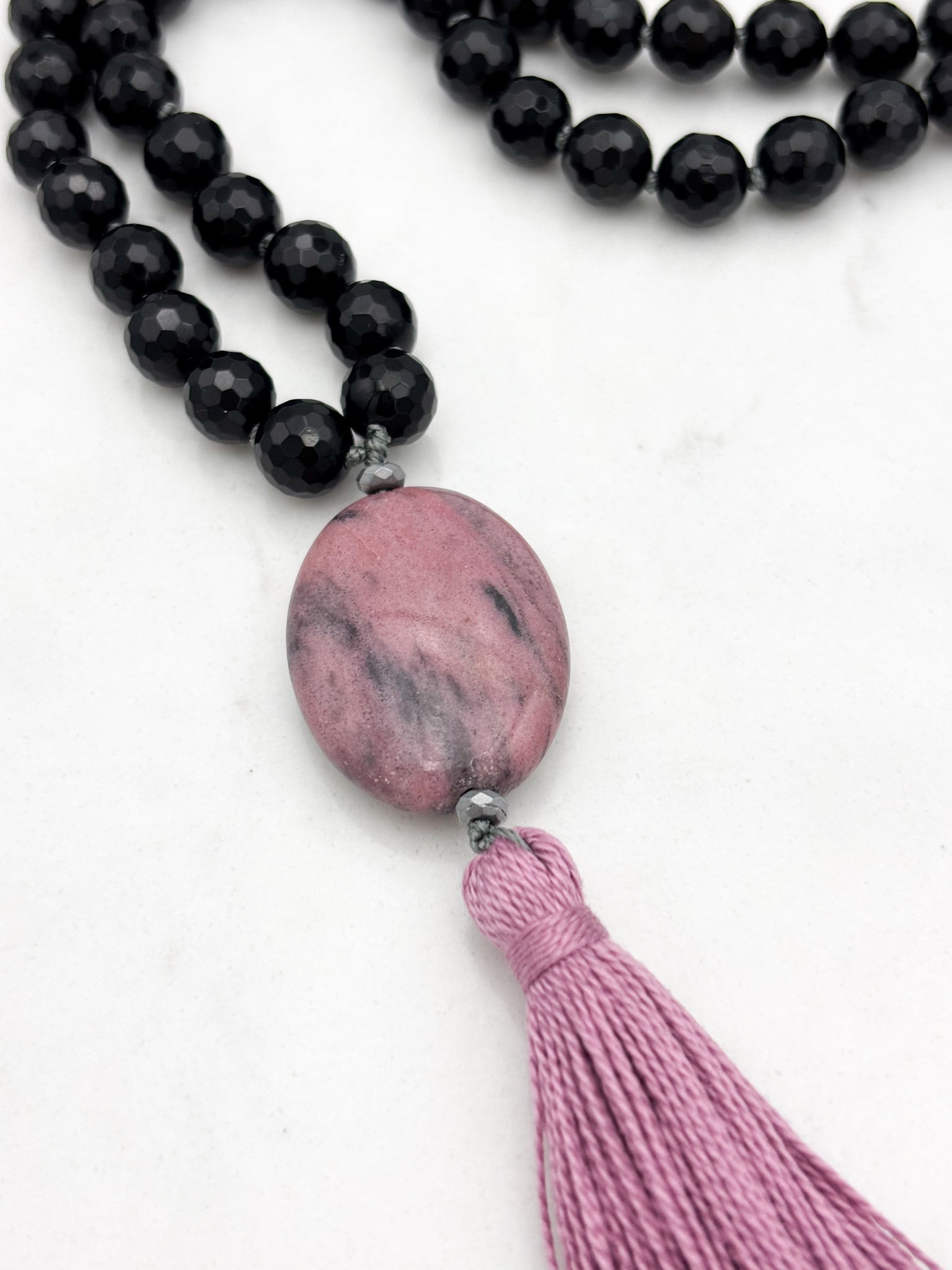 onyx gemstone mala necklace with rhodonite guru bead and pink tassel | radiant malas | handmade in boulder, colorado