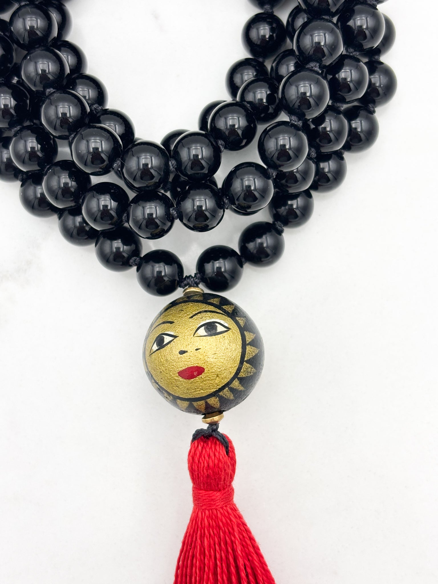 onyx gemstone mala necklace with handpainted wood guru bead and red tassel | radiant malas | handmade in boulder, colorado