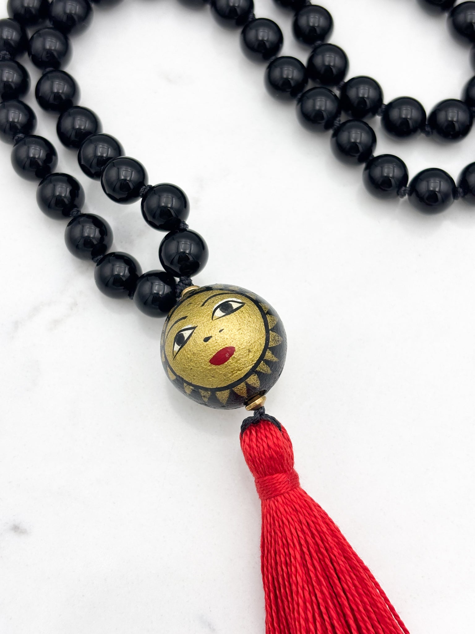 onyx gemstone mala necklace with handpainted wood guru bead and red tassel | radiant malas | handmade in boulder, colorado