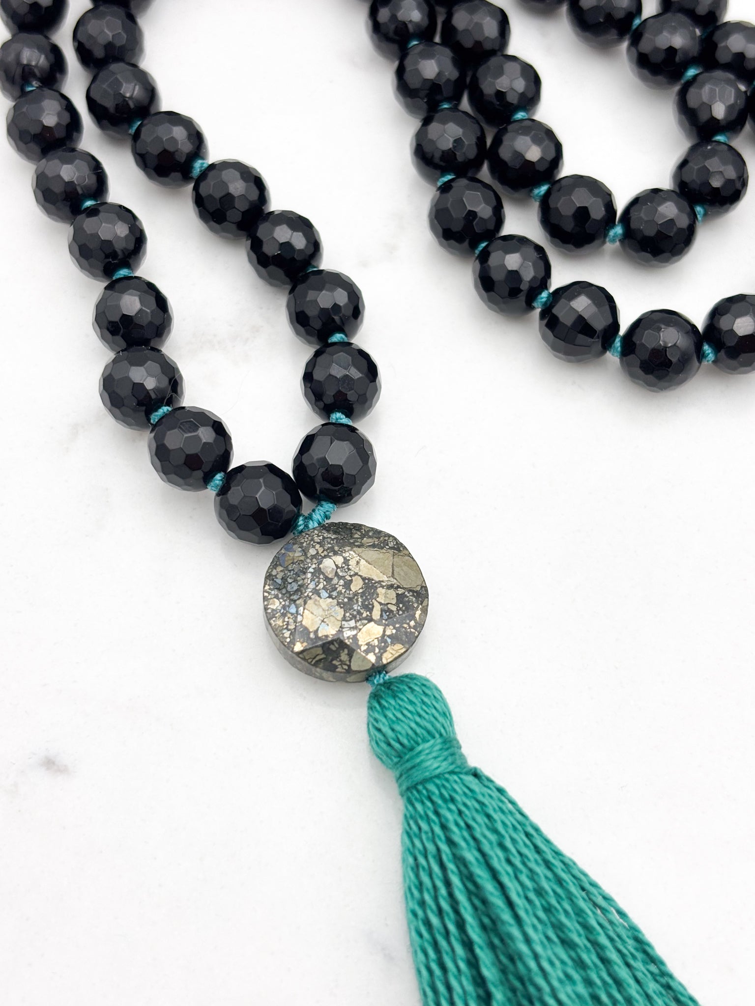 onyx gemstone mala with pyrite guru bead and green tassel | radiant malas | handmade in boulder, colorado