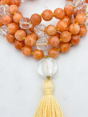 orange calcite with clear quartz gemstone mala with clear lampwork glass guru bead and yellow tassel | radiant malas | handmade in boulder, colorado