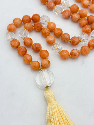 orange calcite with clear quartz gemstone mala with clear lampwork glass guru bead and yellow tassel | radiant malas | handmade in boulder, colorado