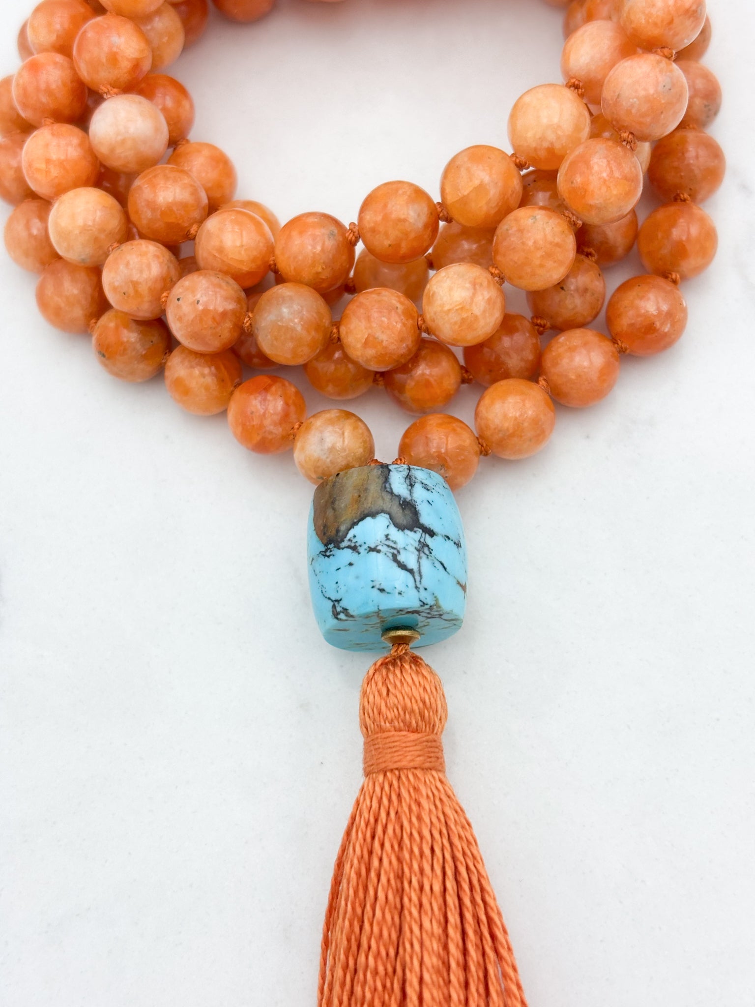 orange calcite gemstone mala with turquoise guru bead and orange tassel | radiant malas | handmade in boulder, colorado