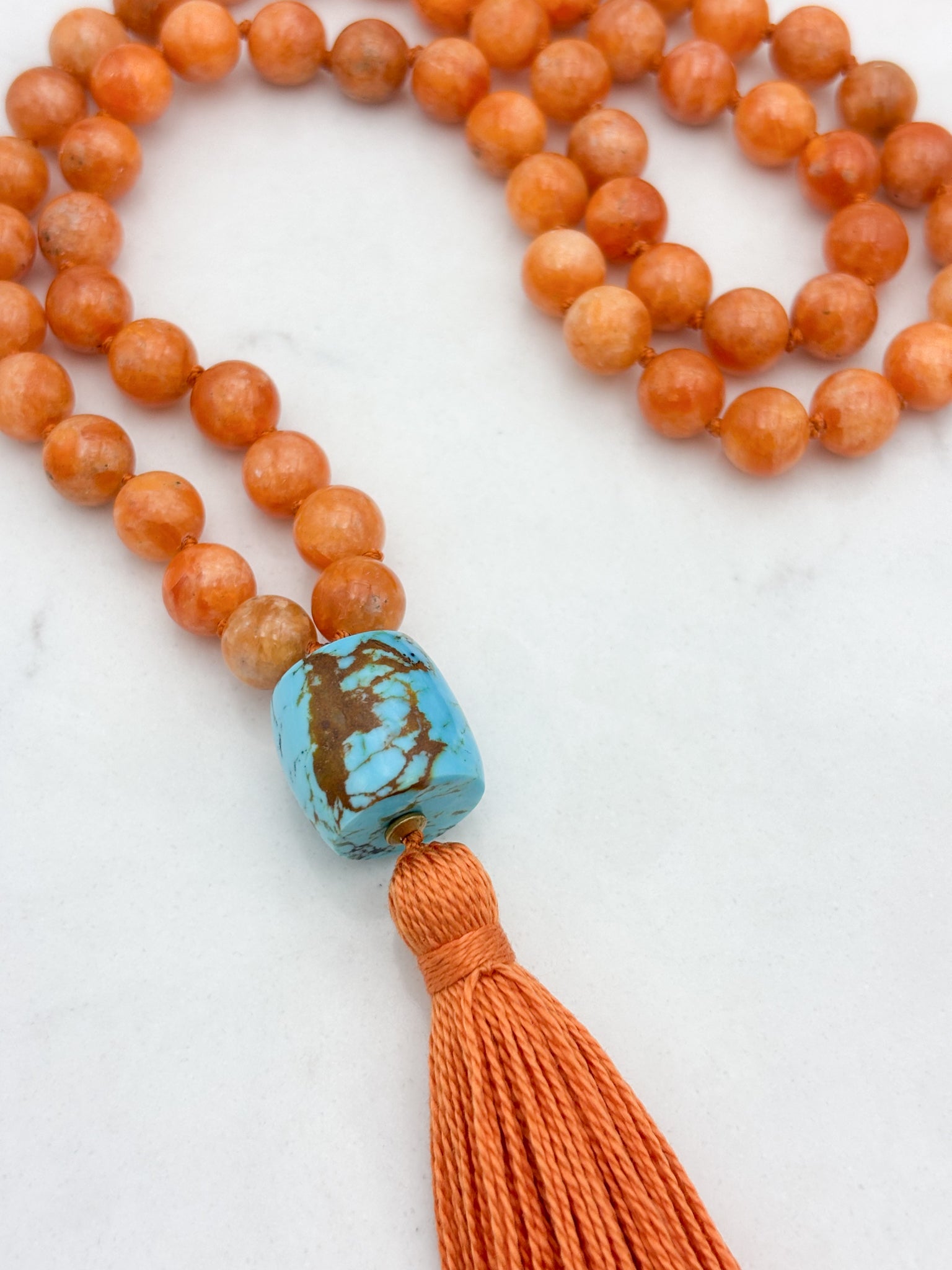 orange calcite gemstone mala with turquoise guru bead and orange tassel | radiant malas | handmade in boulder, colorado