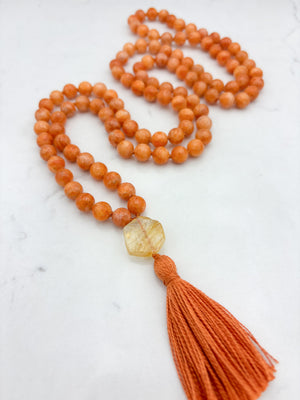 orange calcite gemstone mala with citrine guru bead and orange tassel | radiant malas | handmade in boulder, colorado