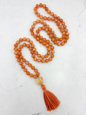 orange calcite gemstone mala with citrine guru bead and orange tassel | radiant malas | handmade in boulder, colorado