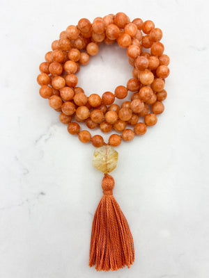 orange calcite gemstone mala with citrine guru bead and orange tassel | radiant malas | handmade in boulder, colorado