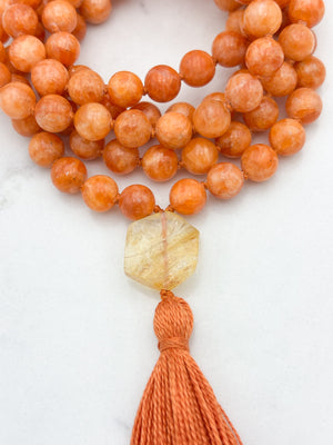 orange calcite gemstone mala with citrine guru bead and orange tassel | radiant malas | handmade in boulder, colorado