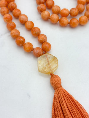 orange calcite gemstone mala with citrine guru bead and orange tassel | radiant malas | handmade in boulder, colorado