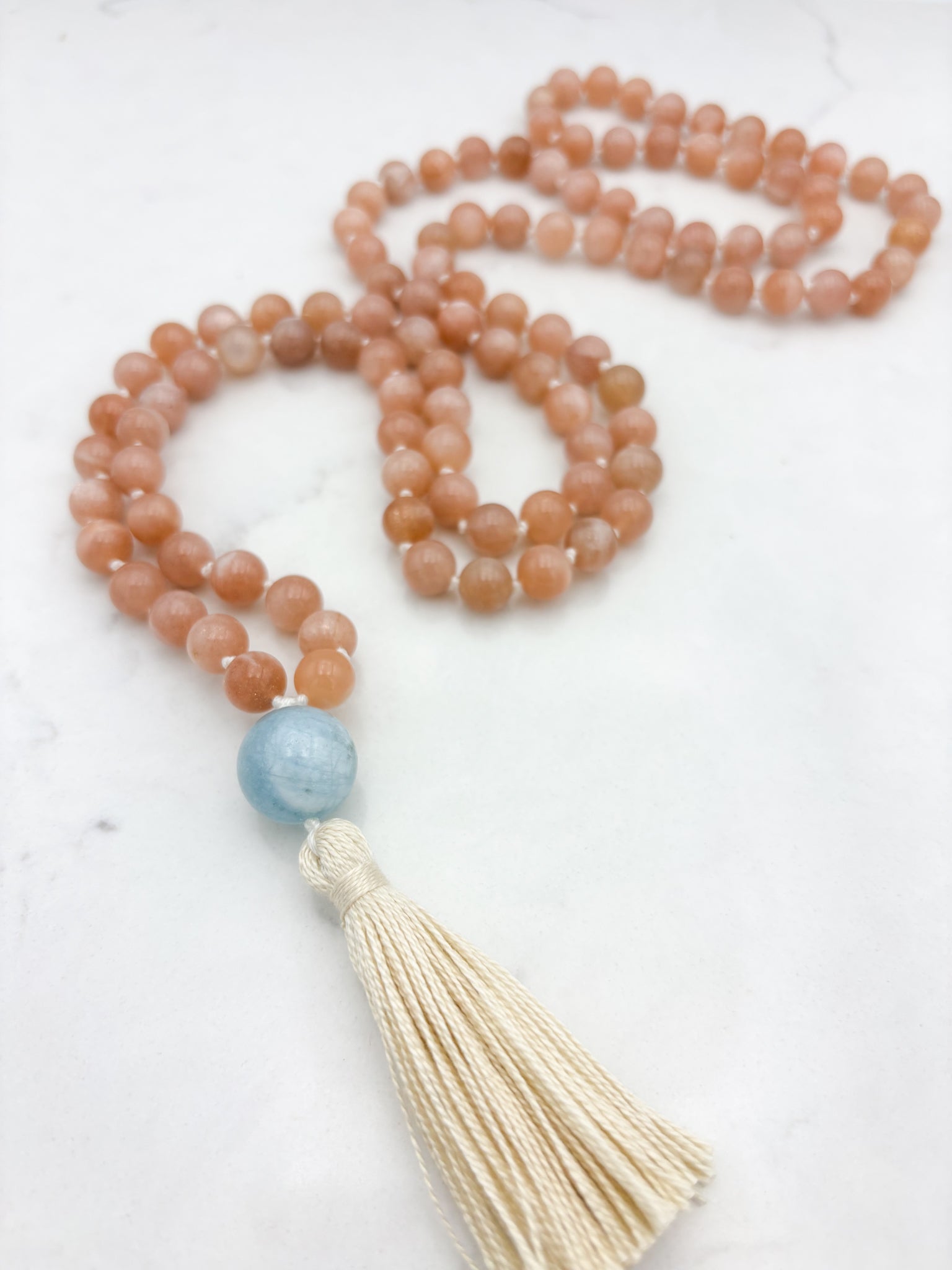 peach moonstone gemstone mala with aquamarine guru bead and cream tassel | radiant malas | handmade in boulder, colorado