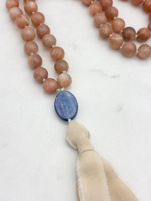 peach moonstone gemstone mala with kyanite guru bead and cream silk  tassel | radiant malas | handmade in boulder, colorado