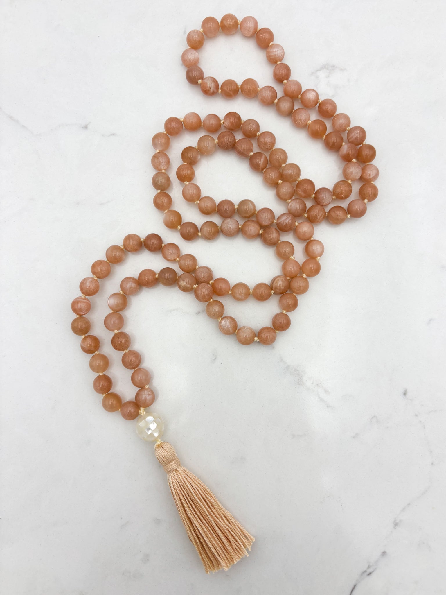 peach moonstone gemstone mala with mother of pearl guru bead and peach tassel | radiant malas | handmade in boulder, colorado